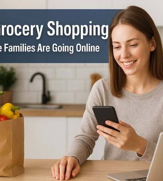 A smiling woman sitting in her kitchen uses her smartphone for online grocery shopping